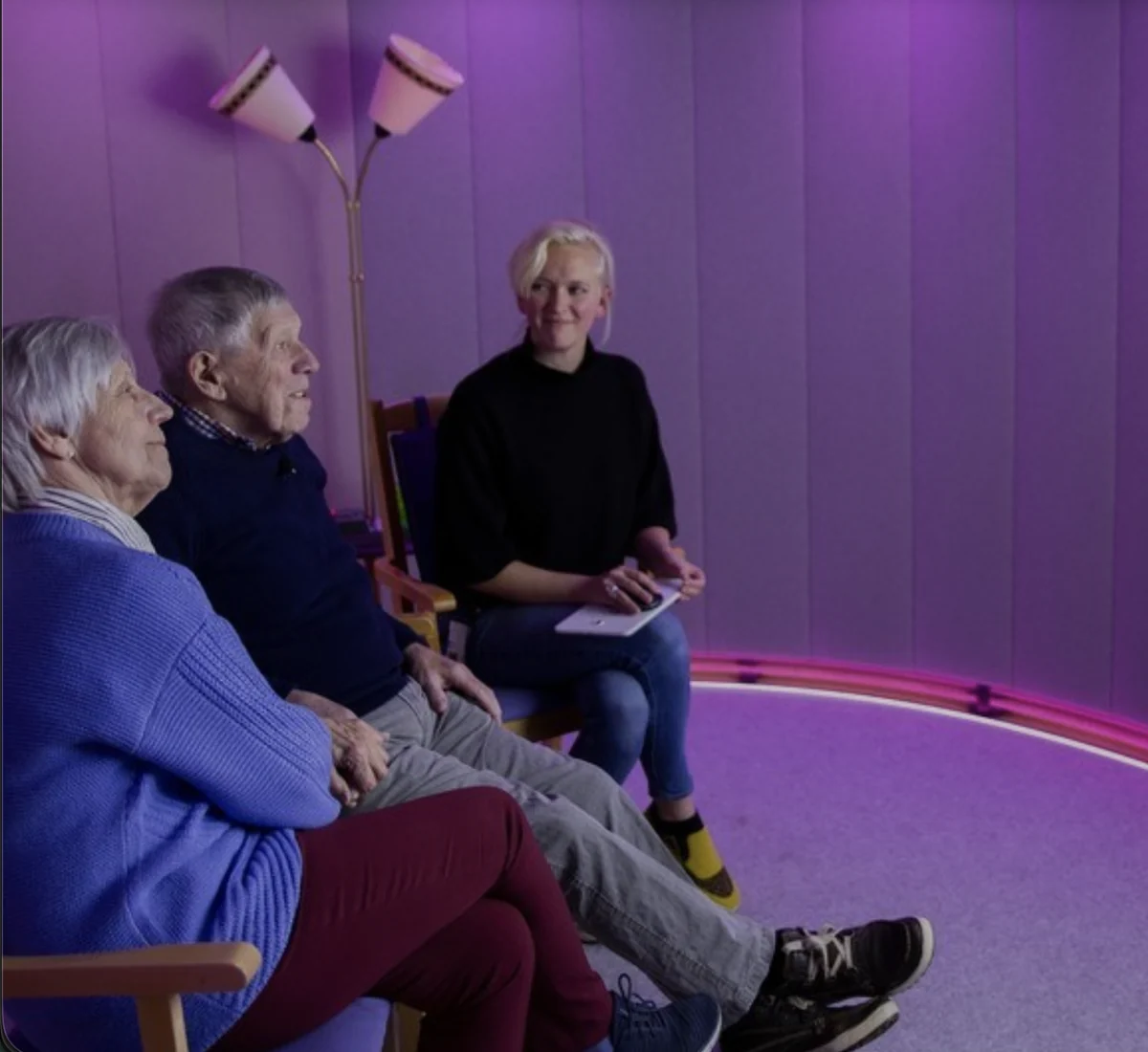Two residents and a caregiver in a Sense-Garden room during a session